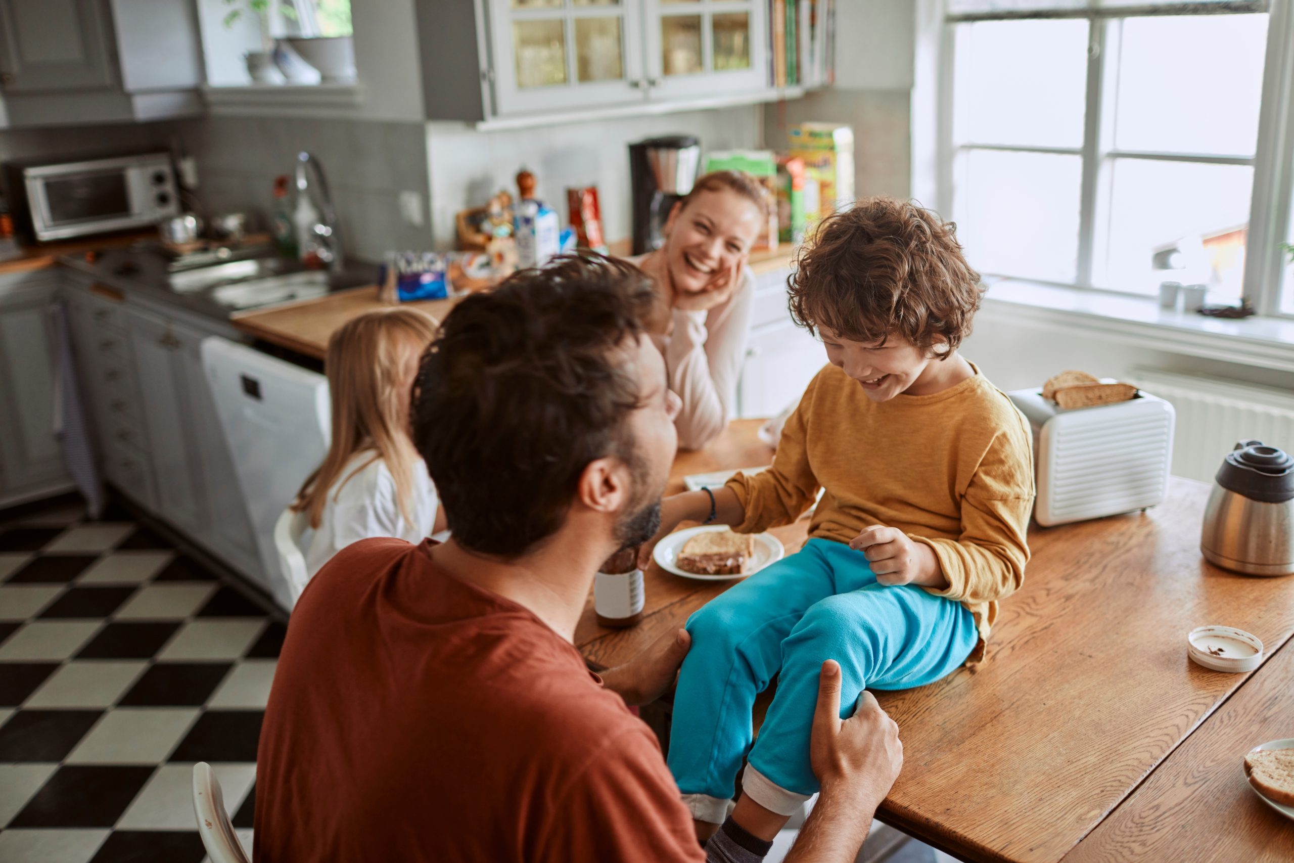 Happy,Family,Having,Fun,In,Kitchen,During,Breakfast